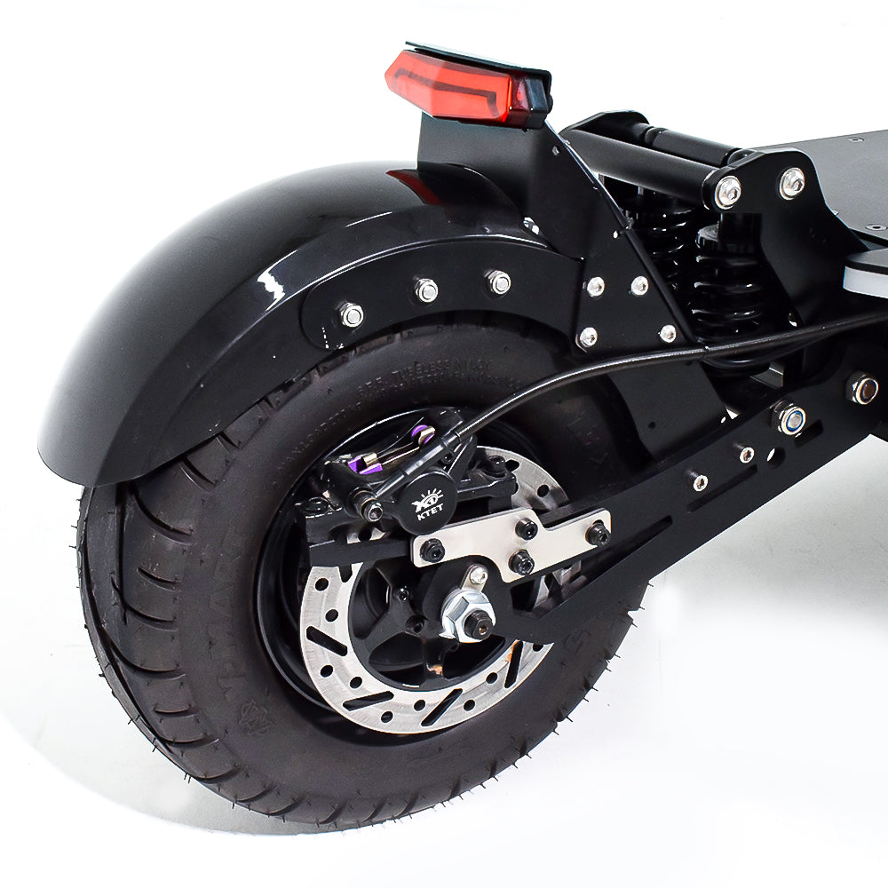 A close-up of the rear wheel of an electric scooter, showcasing the disc brake system and sturdy fender. The design emphasizes durability and efficient braking performance.