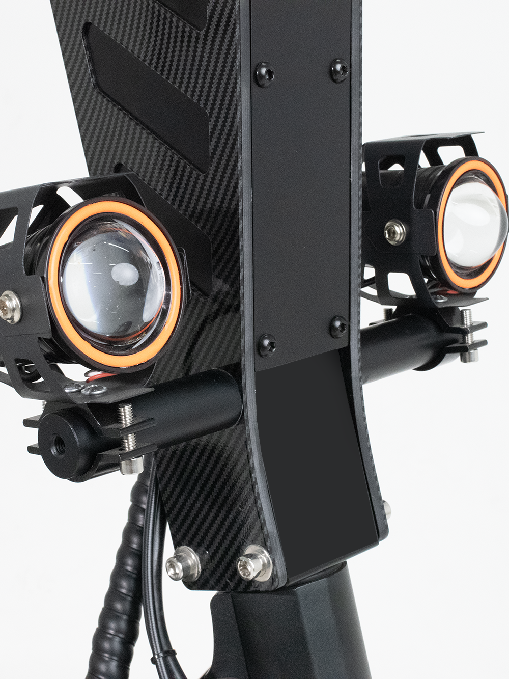 A detailed view of the dual headlights on an electric scooter, mounted on a carbon fiber frame, emphasizing the scooter’s powerful lighting system for enhanced safety and visibility.