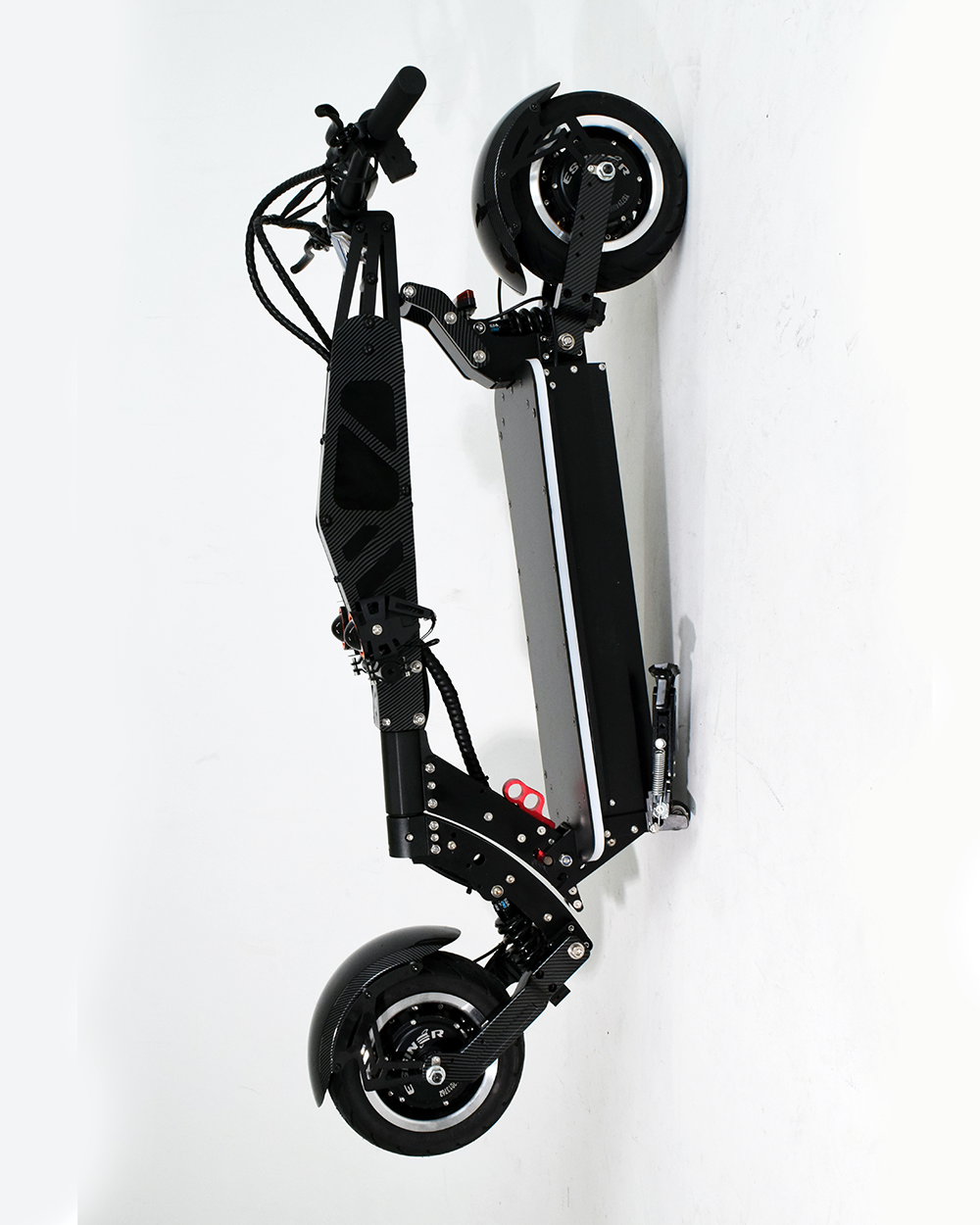 An off-road electric scooter folded for easy storage, showcasing its portability and compact design. The scooter’s durable construction is visible even in the folded state.