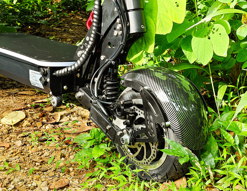 Close-up of the rear suspension system and tire of an off-road electric scooter, highlighting the rugged design and durable components suitable for rough terrains.