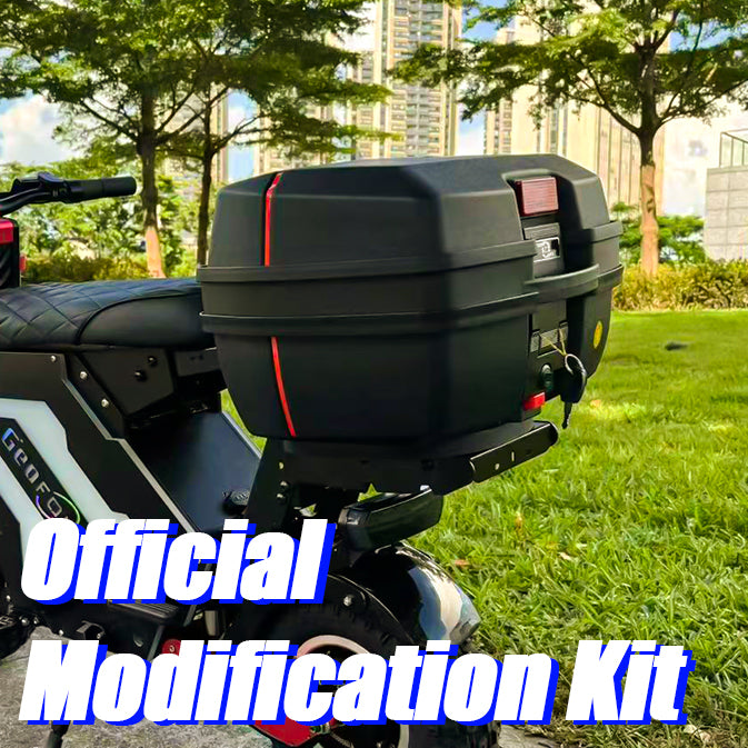 A side view of an electric motorbike equipped with a large rear storage box, parked on a grassy area with tall buildings in the background. The motorbike features a sleek, modern design, ideal for urban commuting and cargo transport.
