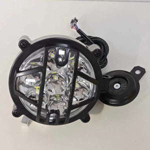The electric motorcycle is equipped with a headlight and horn. These bulbs are arranged in a circle and are located in a solid black grille, which provides protection and creates a stylish look. A horn is mounted on the side for safety.