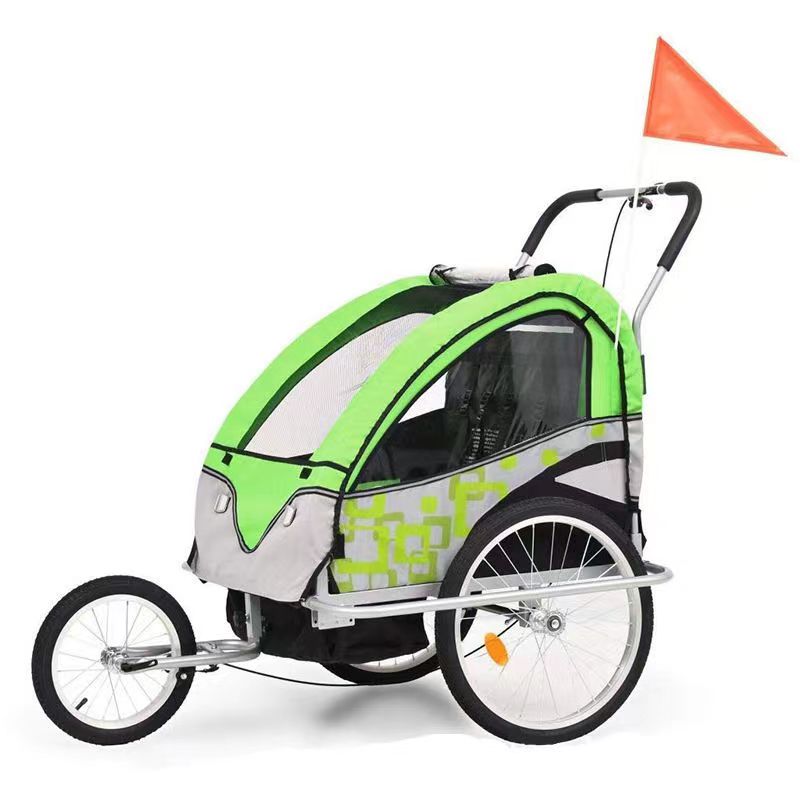 The child trailer, in vibrant green and grey, features large mesh windows for ventilation and excellent visibility. This trailer is designed to be securely attached to your electric scooter, ensuring a smooth and safe ride. It features a durable frame and a spacious interior, complete with seatbelts. An orange safety flag extends from the back for increased visibility, making it ideal for both city commutes and leisurely strolls.