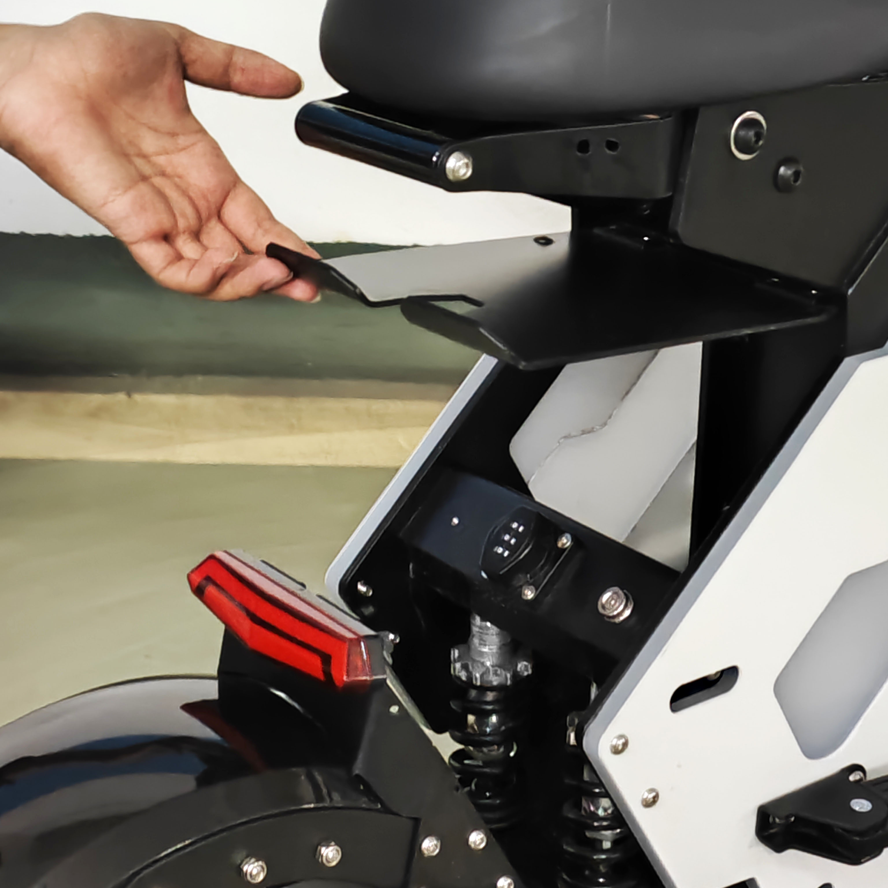 Demonstrating the trunk storage space of an electric motorcycle, allowing for easy access to items