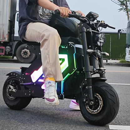 "On a city street, a rider in casual clothes rides a Yisuntrek electric motorcycle with colorful LED lights, showing off the motorcycle's cool lighting and stylish appearance"