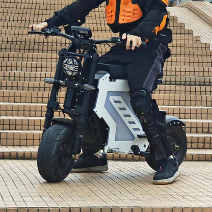 "A rider wearing full protective gear maneuvers a Yisuntrek electric motorcycle down a set of urban stairs, demonstrating its durability and multi-terrain design"